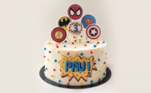 Superhero-Themed Cake With Edible Logos